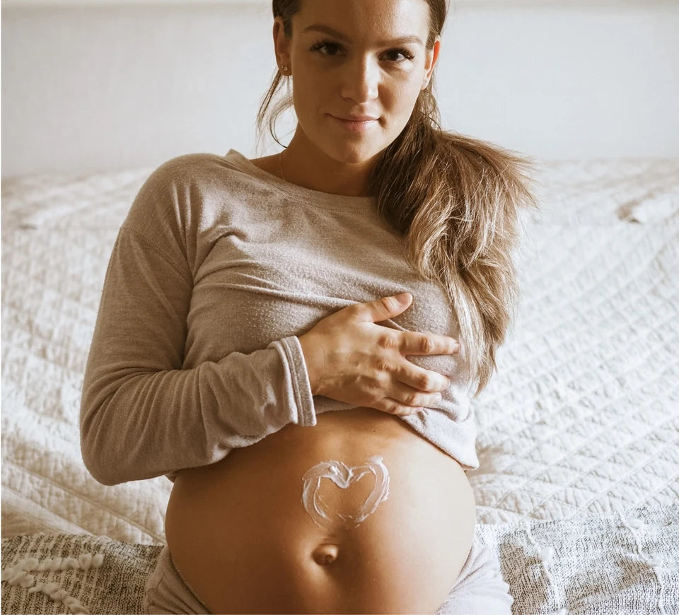 Massaging belly-care serum into the skin